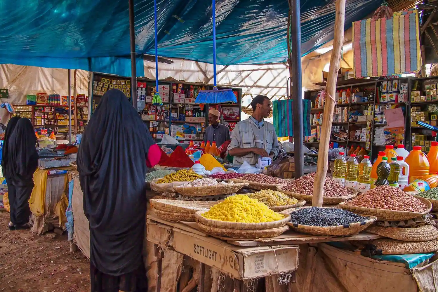 woman near spice seller in Rissani Souk Morocco Market